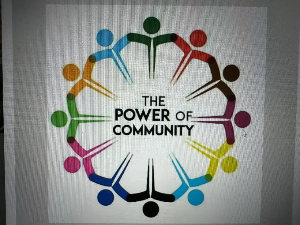 Community members gather together around a table.